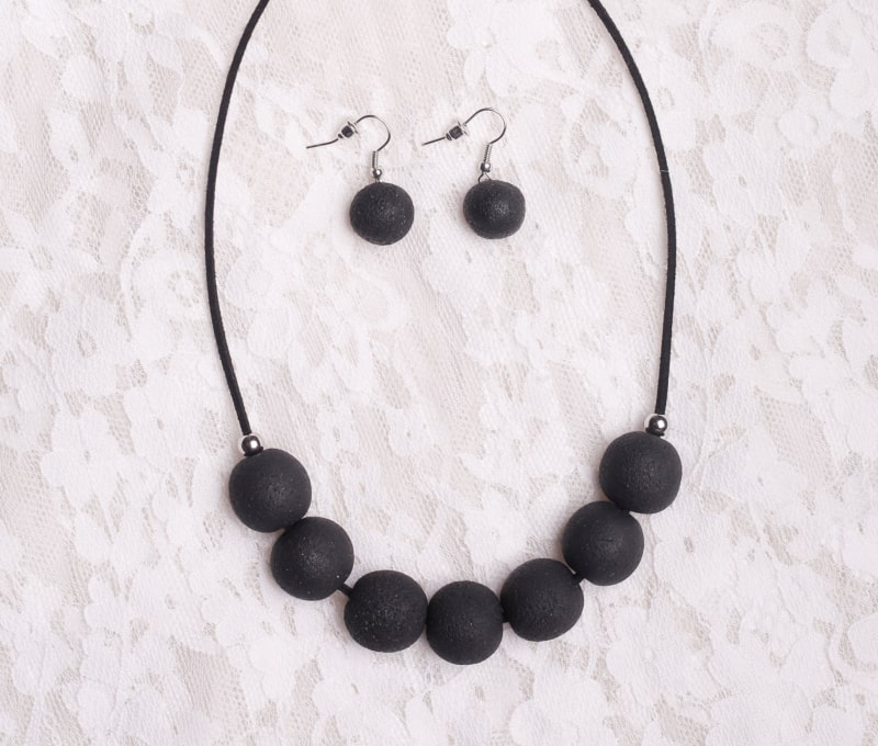 Elegant black necklace made of seven round rough surface beads